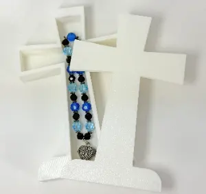 Detailed view of the cross's hidden interior compartment for storing locks of hair or prayer notes.